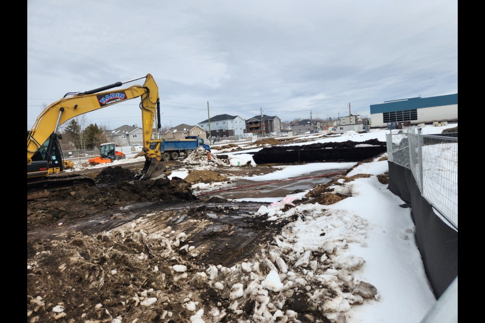 An excavator is working at the site of a 58-unit youth transitional housing development on Junot Avenue. (TBnewswatch photo)
