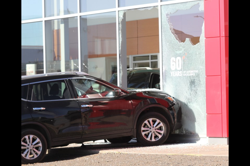 A car shattered two large windows at a local dealership Wednesday morning. 