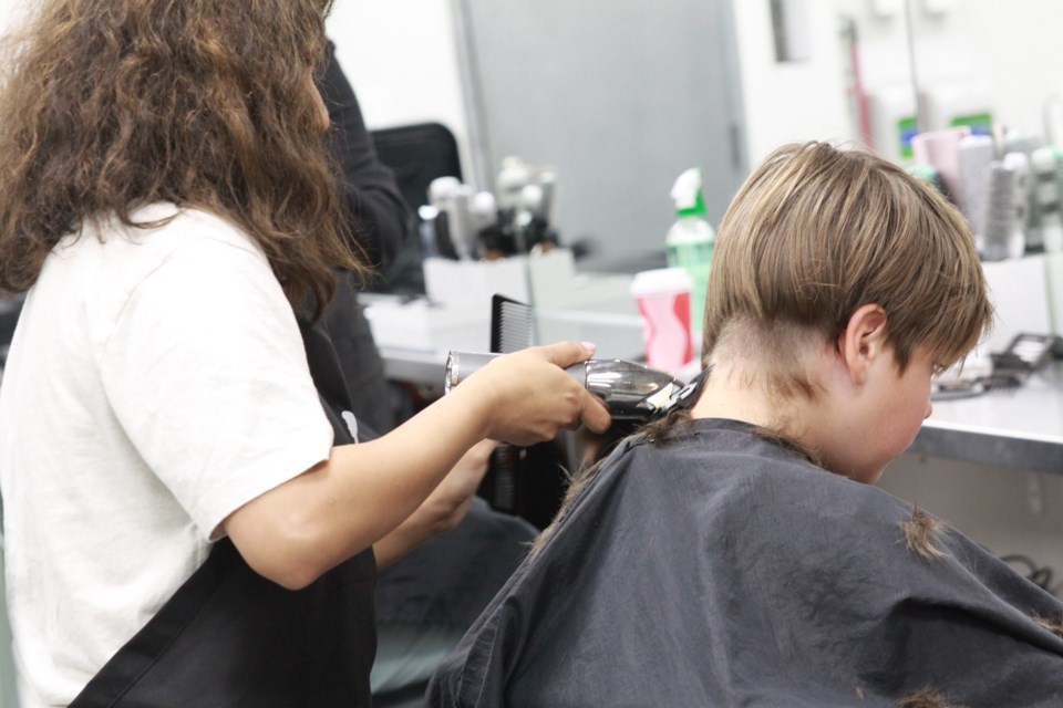 NuWave School of Hair Design student providing a free haircut