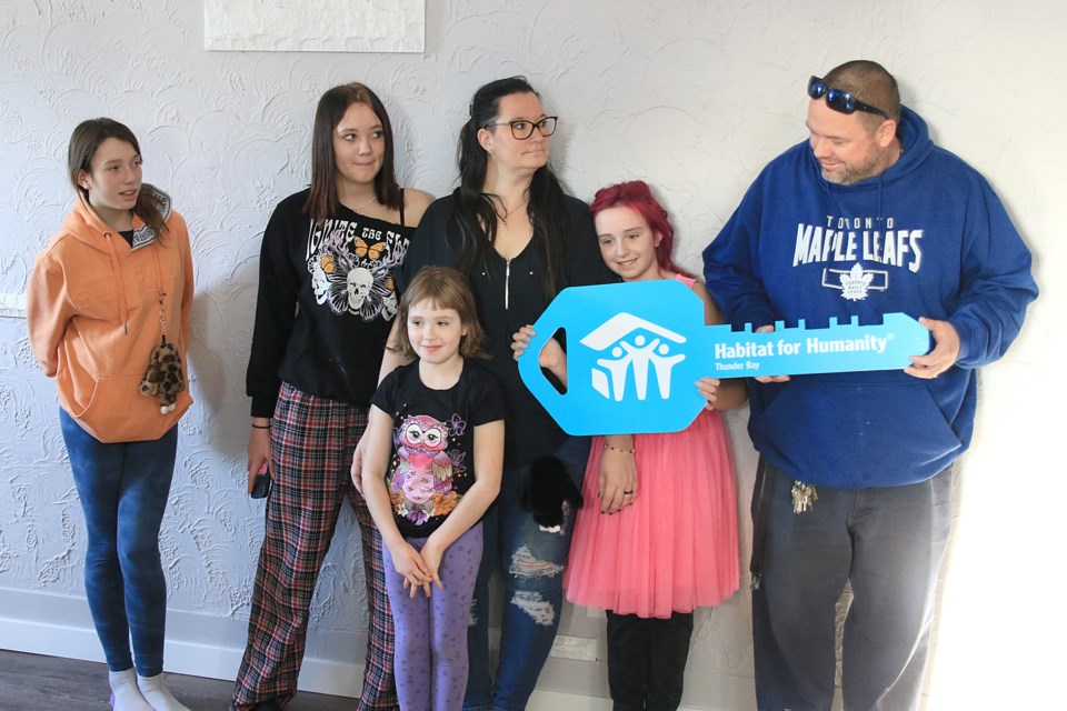 The Martin family took possession of their McLaughlin Street home from Habitat for Humanity on Thursday, Dec. 12, 2024. From left: Athena, 11, Shyann, 13, Rylee, 7, Candis, Annabelle, 11, and Mike. (Leith Dunick, tbnewswatch.com)