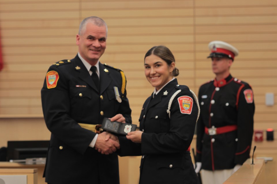 Duty Chief Ryan Hughes presents Constable Caitlin Radcliff with her badge. 