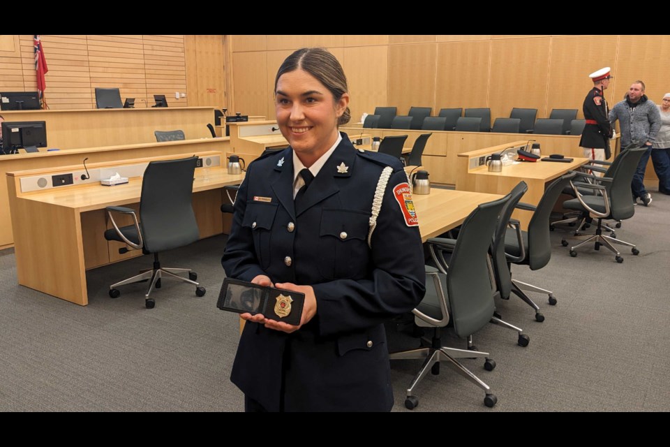 Constable Caitlin Radcliff takes a photo with her badge.