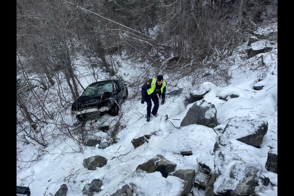 Const. Blanco of the OPP Marathon detachment climbed down to the vehicle to check on the condition of the driver (OPP/Facebook)