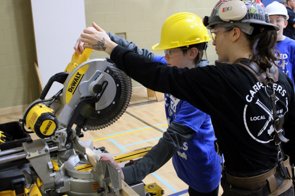 Julia Lennips teaches proper safety technique during a carpentry lesson at the Got Skillz Skilled Trades Bootcamp at Woodcrest Public School on Tuesday.