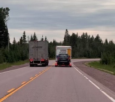 OPP posted a photo of a transport truck overtaking another vehicle on Highway 11/17 near Hurkett (OPP/Facebook)