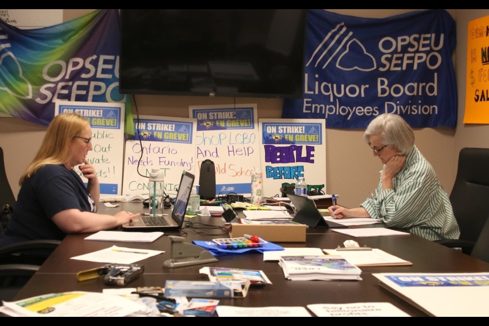 Mo Marsonet, vice-president of Local 741 of the Liquor Board Employees Division of OPSEU, from right, and treasurer Crystal Herman preparing for a possible strike on Friday. 