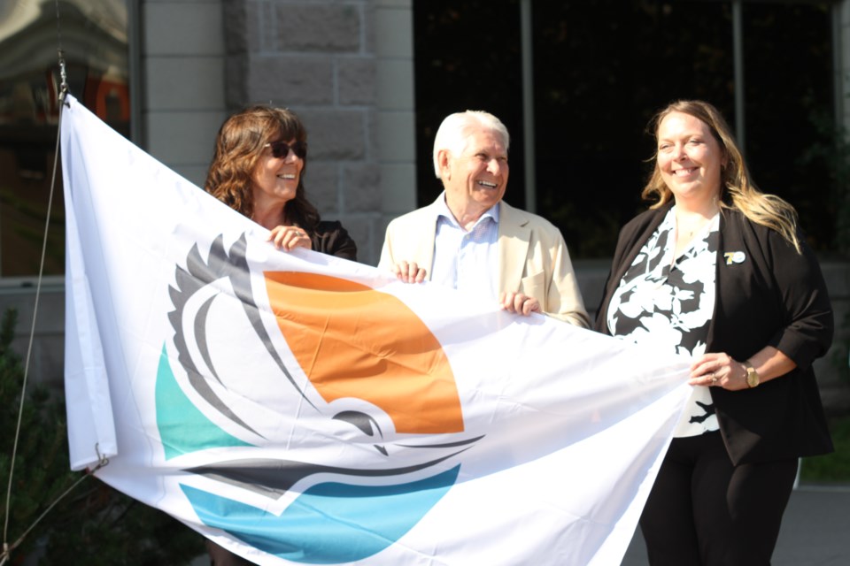 The LRCA's flag was raised at city hall to commemorate 70 years in the community. From left, Donna Blunt, Mayor Ken Boshcoff, and Tammy Cook participated.
