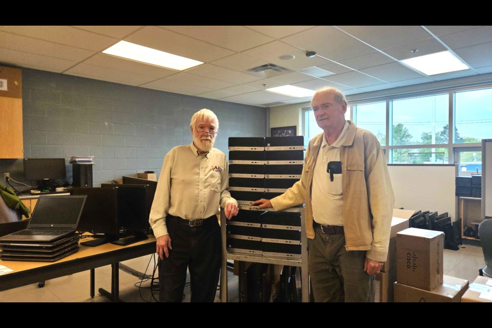 Dr. Jerome Harvey and Tom Baxter are sending used computers to students in Ecuador that were donated by the public school board. 