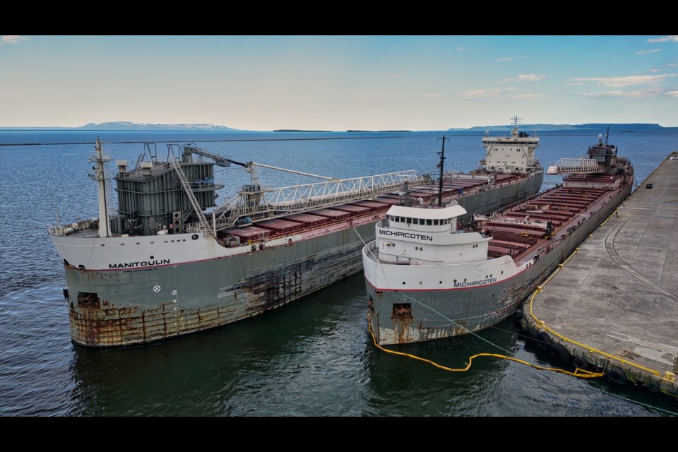 The damaged Great Lakes bulk carrier Michipicoten unloaded its cargo of taconite pellets into the hold of the Manitoulin at Keefer Terminal (Michael Hull photo)