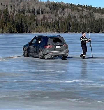 A damaged SUV rests on the ice of Dunc Lake after a collision on Highway 17 on March 11,2024 (OPP/Facebook)