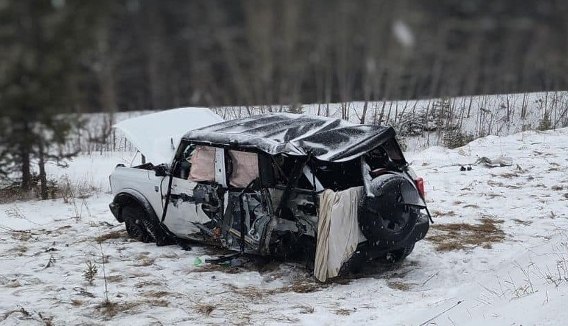 An OPP photo shows extensive damage to an SUV involved in a collision with a truck hauling two logging trailers on Highway 105 on March 26, 2024 (OPP/Facebook)