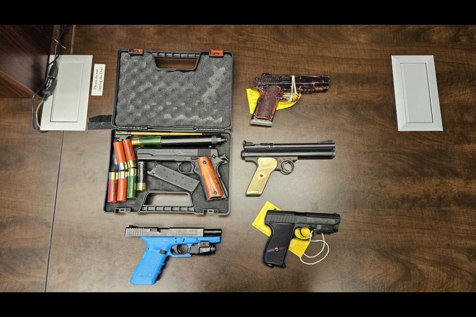 Police displayed a selection of imitation guns including airsoft pistols, a pellet gun, a TBPS training gun, and a plastic toy gun. 