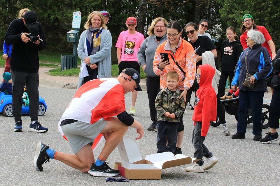 Ryan Keeping accepts a box of Persians in Thunder Bay on Tuesday, May 28, 2024. (Leith Dunick, tbnewswatch.com)