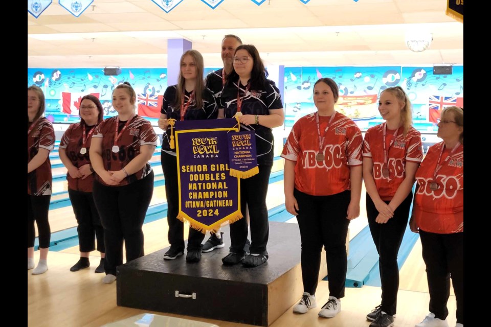 Jordyn Graham, left, and Isabelle Hayden are joined by coach Richie Baccari after they won the gold medal in the senior girl doubles event at the 2024 YBC Nationals.