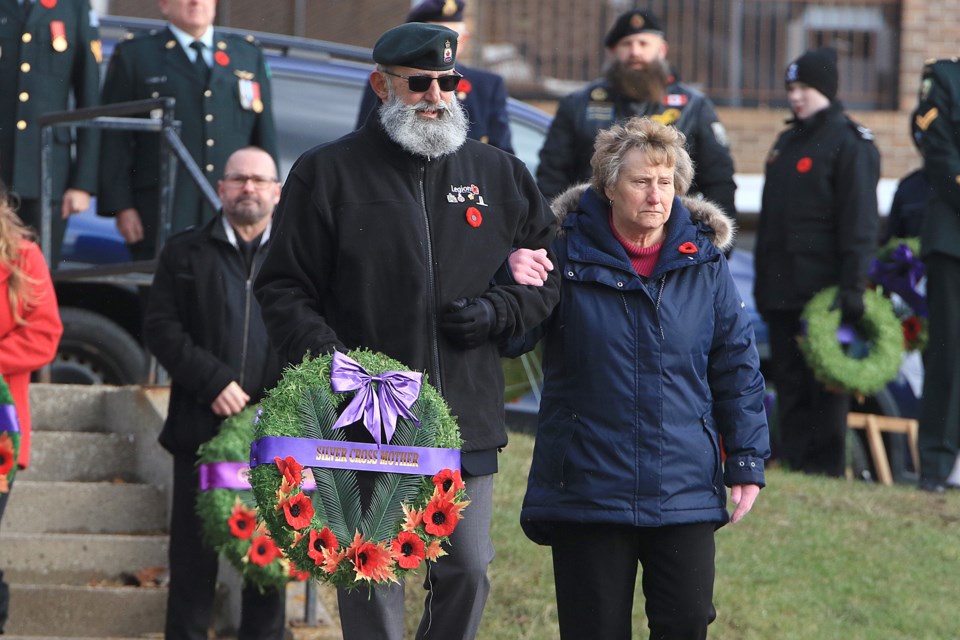 Dorothy Sdraulig, the aunt of Cpl. Anthony Boneca, who gave his life in 2006 serving his country in Afghanistan, was escorted to the Waverly Park cenotaph by George Romick on Monday, Nov. 11, 2024, to lay the silver cross mother wreath during Remembrance Day ceremonies in Thunder Bay. (Leith Dunick, tbnewswatch.com)