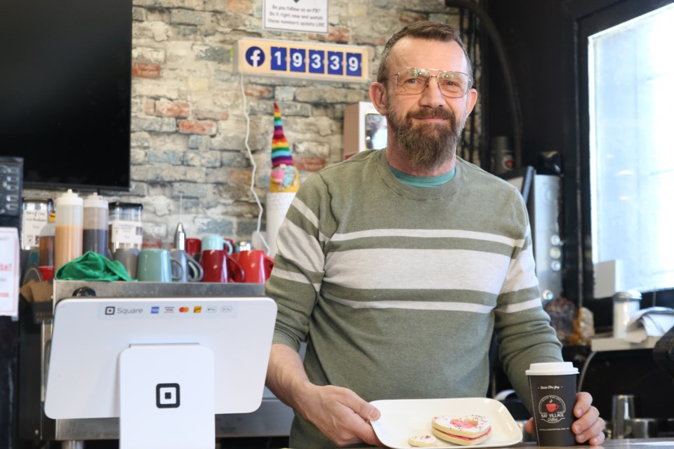 Alan Forbes, the owner of Bay Village Coffee, displays the heart-shaped buttercream cookies sold for the fundraiser on April 7.