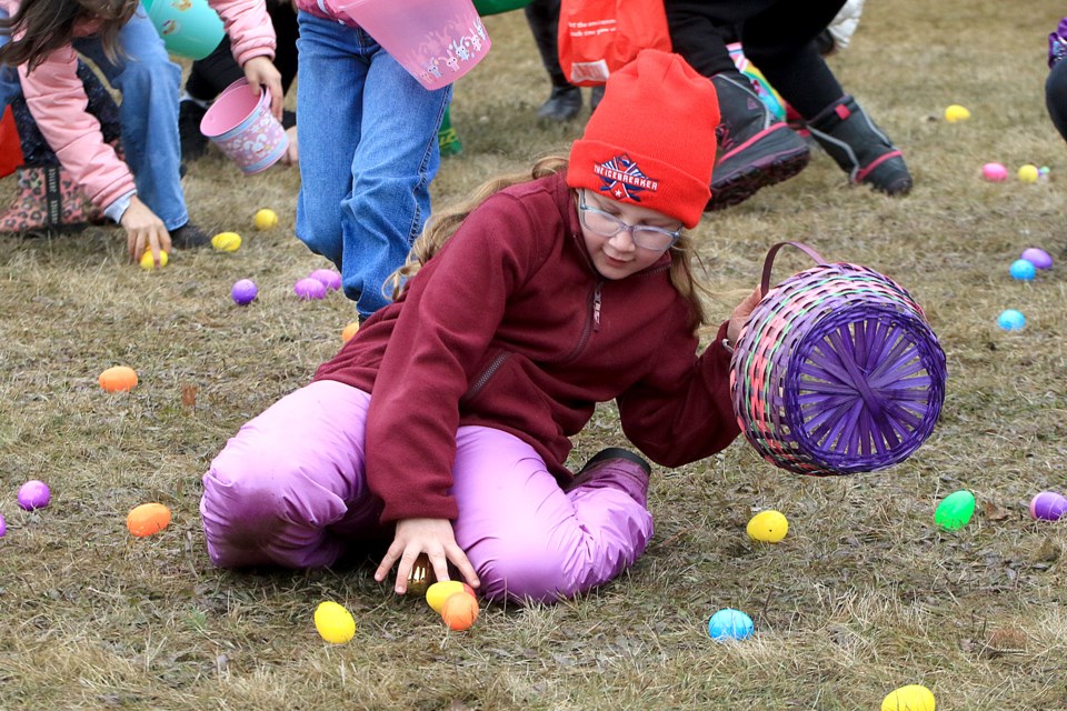 Ivy Heatley, 9, slides into a pocket of Easter eggs on Friday, April 18, 2025 at the annual Hill City Kinsmen East End Easter Egg Hunt. (Leith Dunick tbnewswatch.com)