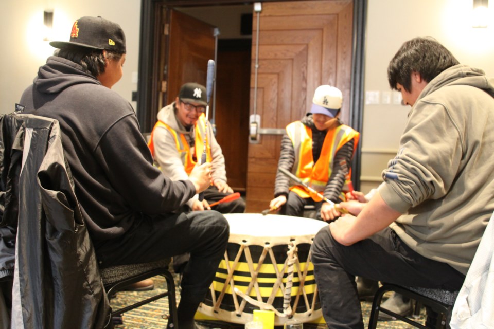 Evacuated Neskantaga community members drumming at the Valhalla Inn on April 21, 2025.