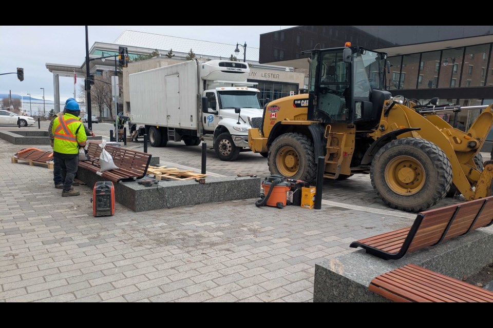 Construction workers install new benches. (April 25, 2025)
