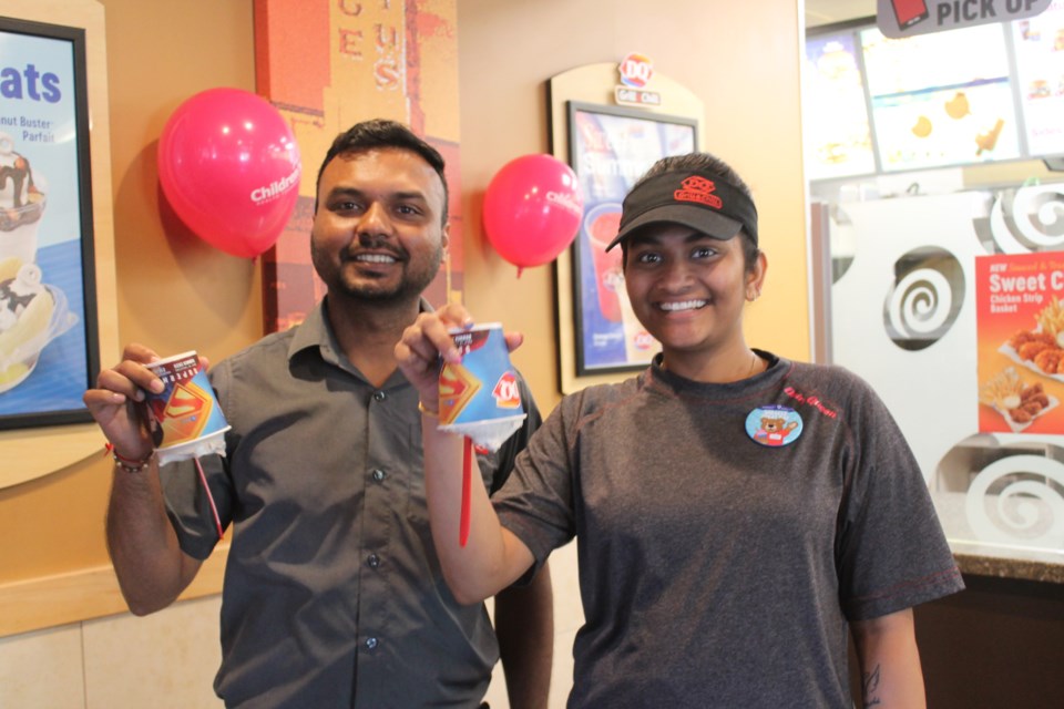 Dairy Queen employees show off Blizzards on Miracle Treat Day on Aug. 14, 2025. 