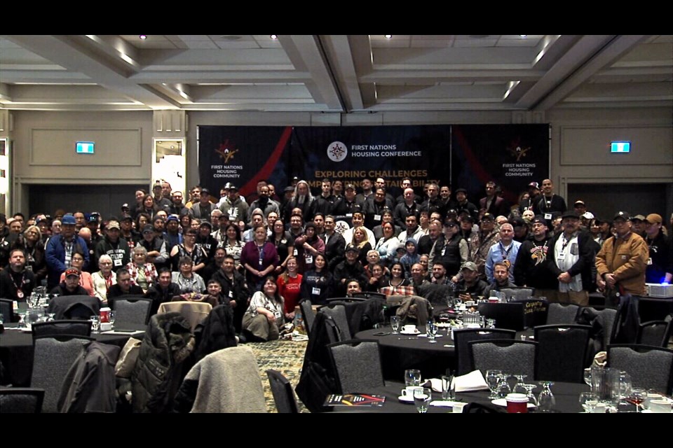 A group photo of delegates at the 2025 First Nations Housing Conference taken after Tuesday morning's opening ceremonies.