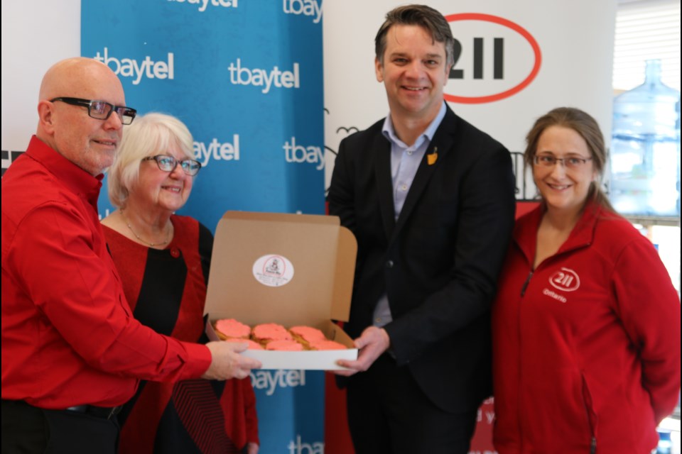 Albert Brulé, the United Way of Thunder Bay’s CEO; Marie Klassen, the Lakehead Social Planning Council executive director, and Paul Norris, Tbaytel’s president and CEO, left to right, hold a box of the limited edition Persians with a volunteer on Feb. 11.