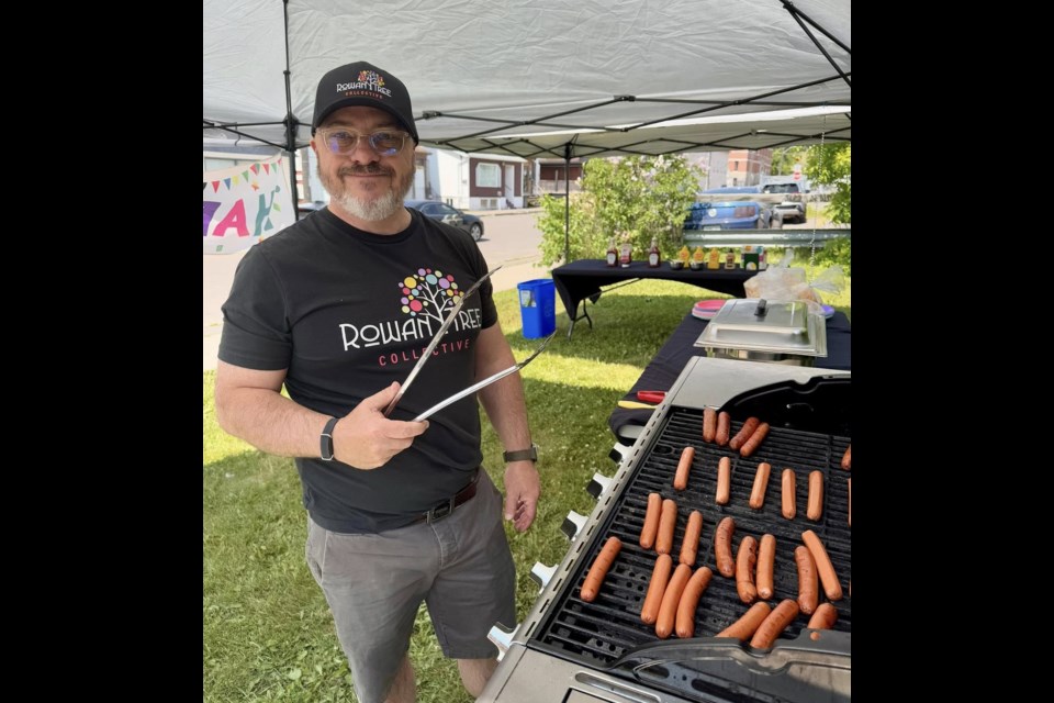 Paul Gibson is shown in this photo using a barbecue before it was stolen from Rowan Tree Collective.  Two donors are replacing it with the identical model   (Rowan Tree Collective/Facebook)