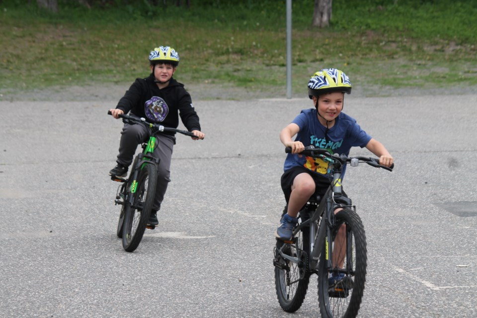 Students testing out their new bicycle helmets on June 10, 2025 at St. Paul School.