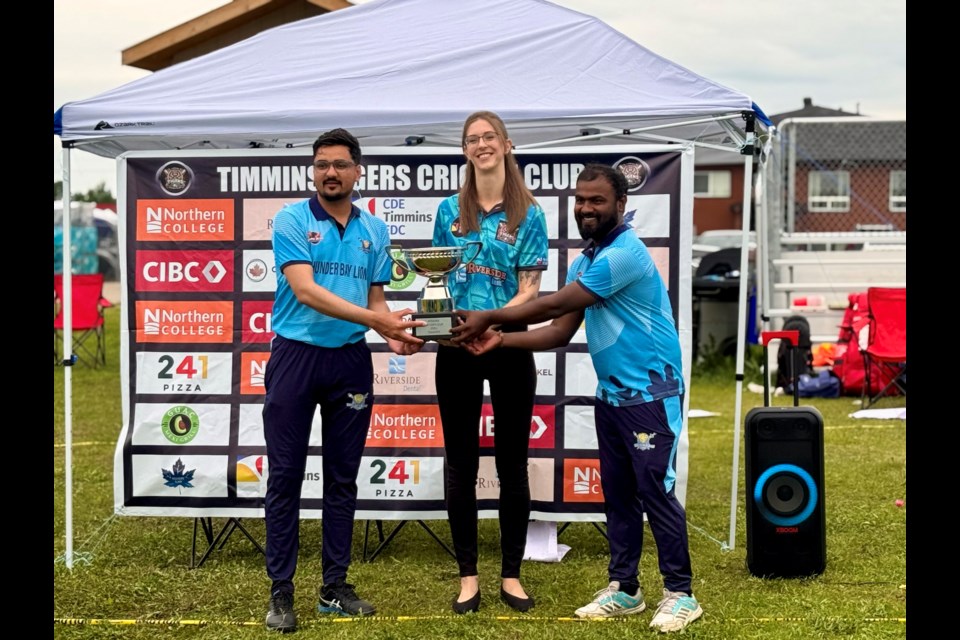 Timmins Mayor Michelle Boileau (c) presents the Mayor's Cup trophy to Thunder Bay Lions cricket club captain Milan Chaudhary (l) and club director Suresh Prajapati (r) on June 22, 2025 (submitted photo)