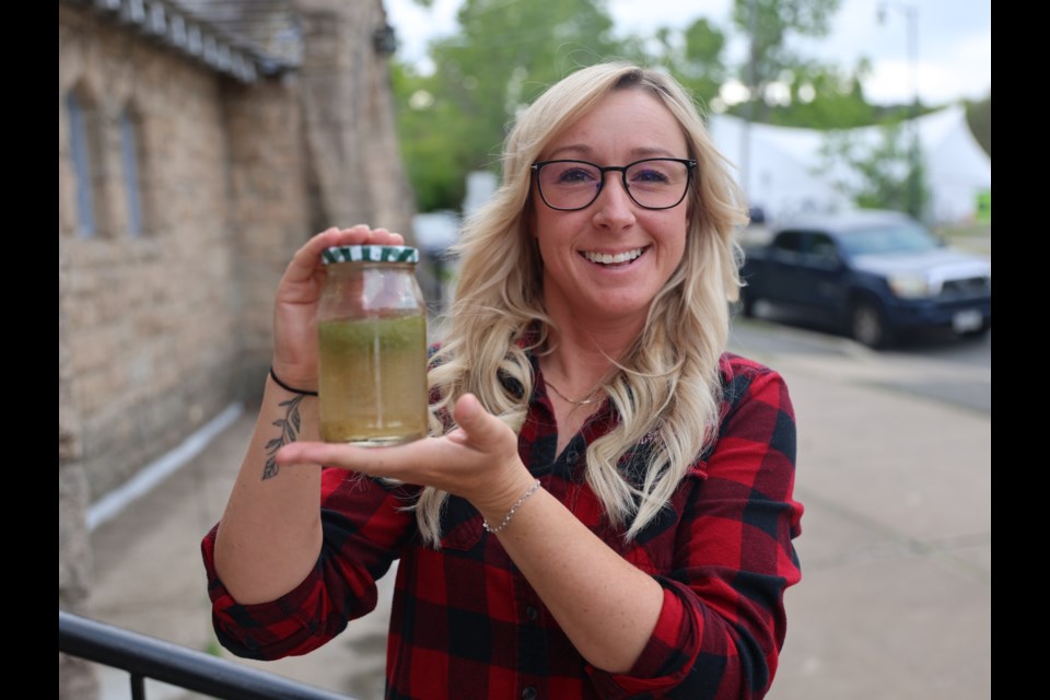 Michelle Willows, the environmental planner at the Lakehead Region Conservation Authority, holds a sample of cyanobacteria.