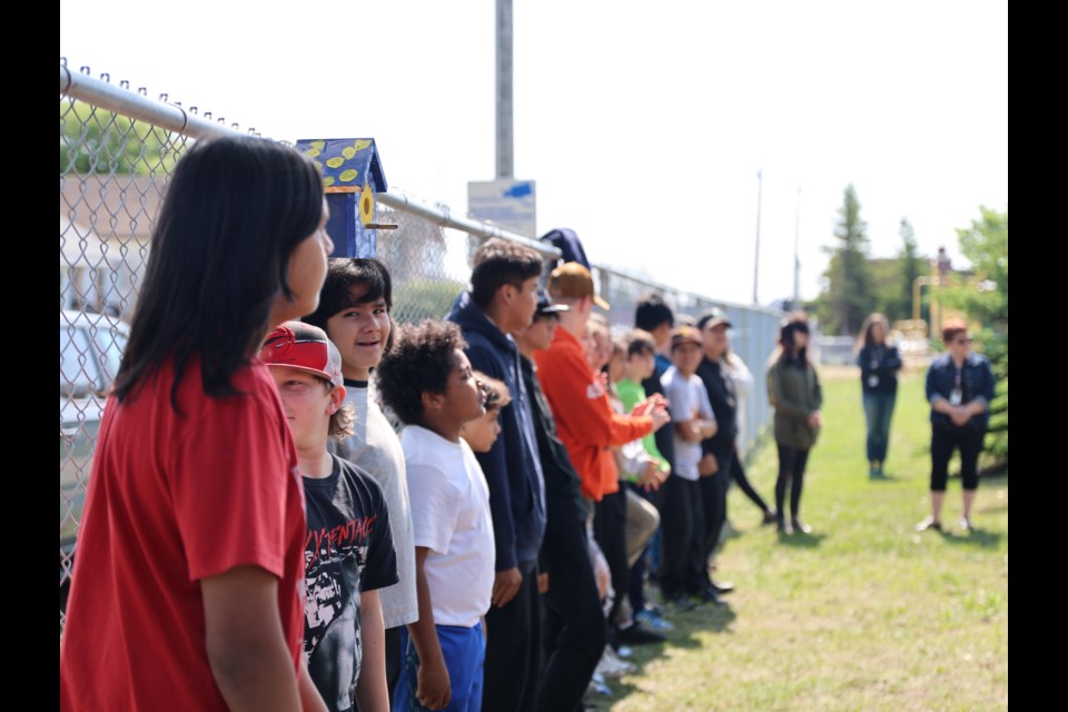 Students at Ogden Community school build and designed a new pollinator garden in honour of former principal Scott Harris, June 12, 2025.