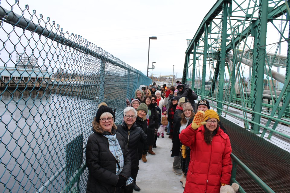 Residents on both sides of the Canada-United States border met at the border crossing bridge between Fort Frances and International Falls to hold hands in allyship at the International Boundary Line on March 29.