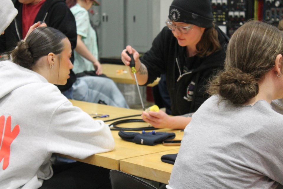 High school girls completing hands-on activities at the International Brotherhood of Electrical Workers Local 402