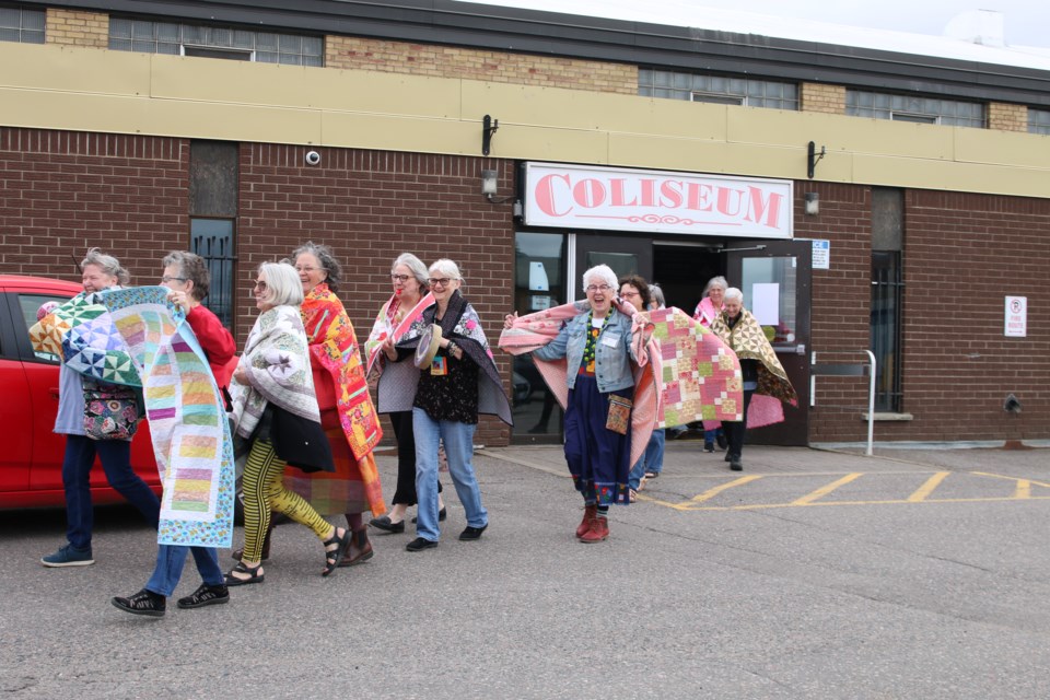 Thunder Bay Quilters Guild members showcase and promote their quilts during a walk from the CLE grounds before the 2025 Superior Quilt Show starts on May 23.