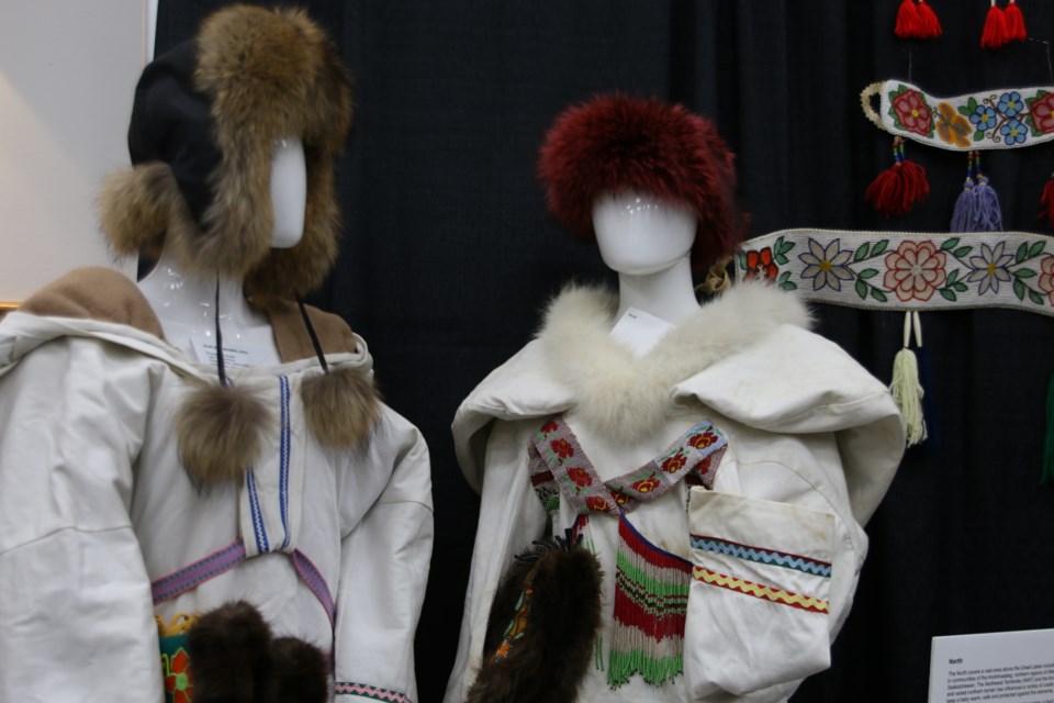 Two traditional amautiit are on display, showcasing the large hoods where babies are kept.