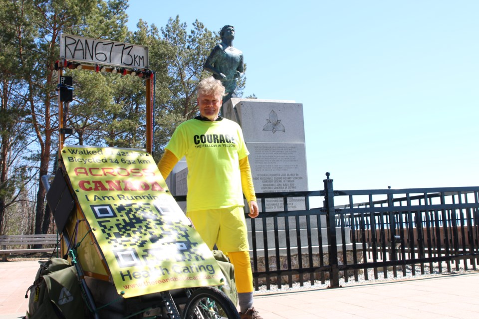 Trevor Redmond, the Fellow in Yellow, made a stop at the Terry Fox monument in Thunder Bay during his run across Canada on May 5.