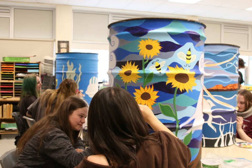 St. Ignatius High School students paint garbage cans to display around Marina Park in Thunder Bay to clean up the waterfront using their art on June 6.