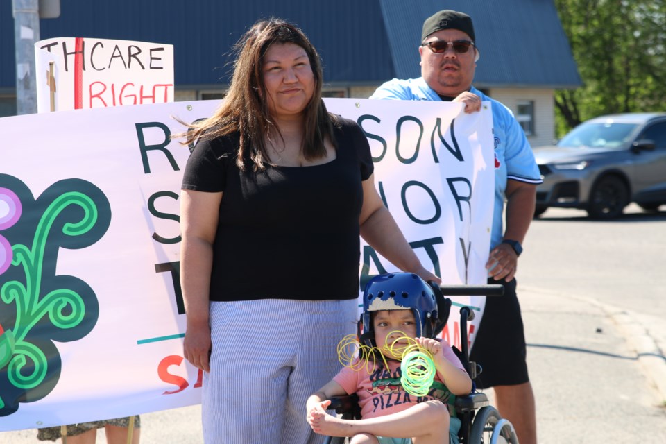 Kiera Michell, Damien Bouchard and their son Zephyr Bouchard, an eight-year-old boy from Fort William First Nation who has been living most of his life without treatment for a brain hernia that he was born with, rally outside of Patty Hajdu’s office on May 30. Michell says Zephyr has largely been discriminated on for being a child with disabilities.