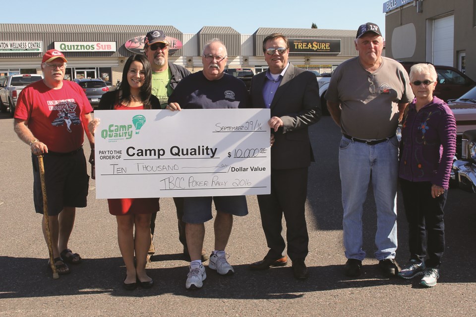 Members of the Thunder Bay District Car Clubs present Rosa Carlino of Camp Quality (second from left) with a cheque for $10; 000; the proceeds of their sixth annual poker run (Leith Dunick; tbnewswatch.com).