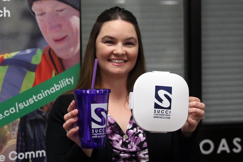 Student Union of Confederation College president Jodi Connor on Thursday, Sept. 22, 2016 displays a resusable glass and lunch kit being given to students in support of the school's sustainability efforts (Leith Dunick, tbnewswatch.com). 