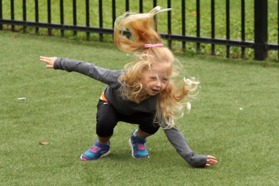 A senior kindergarten student at St. Martin School in Thunder Bay completes a cartwheel on the first day of classes on Sept. 7, 2016. The school constructed a new artificial turf-lined playground over the summer.  (photo by: Leith Dunick, tbnewswatch.com)