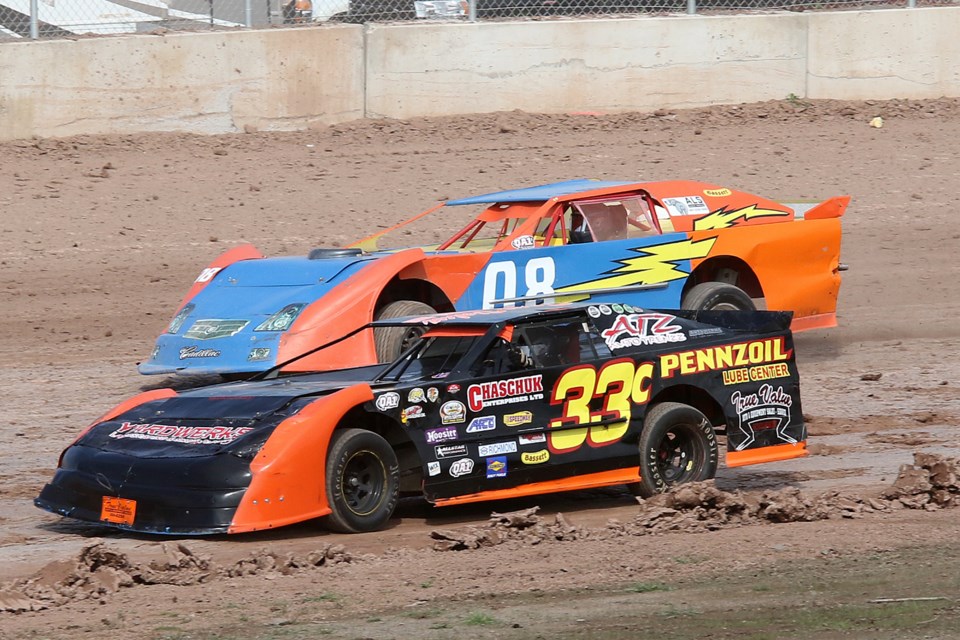 Cole Chernosky (33) and Norm Staal take the third turn at the Thunder Bay Truck Centre Dirt Track Nationals on Sunday, Sept. 18, 2021 at the Dairy Queen International Speedway. (Leith Dunick, tbnewswatch.com)