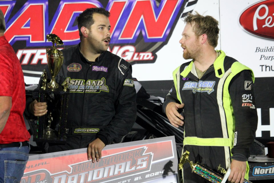 David Simpson, right, chats with Tyler Vernon of Mason, Wisc. following the second night of the Thunder Bay Truck Centre Dirt Track Nationals on Sept. 21.