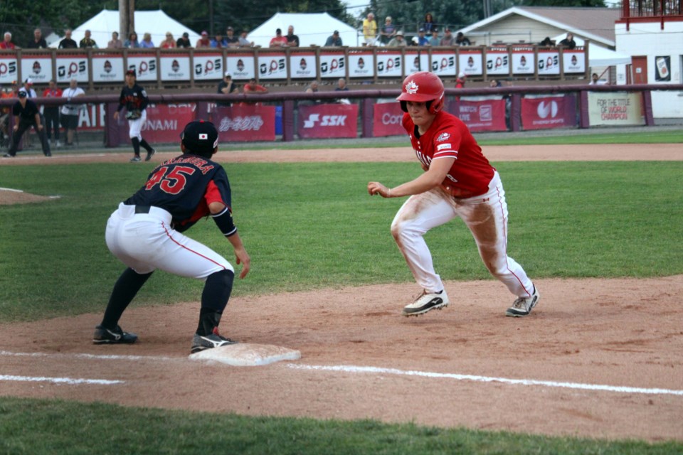 Canada's Sena Catterall sprints back to first place to beat out a pickoff throw by Japan during the bottom of the seventh inning at Port Arthur Stadium on July 29.