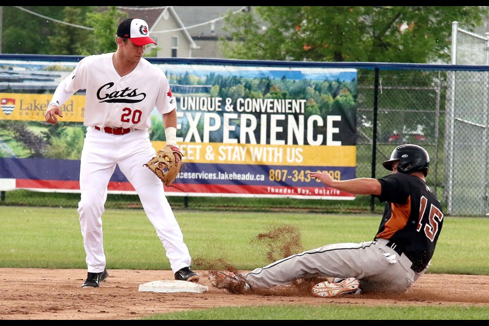Eau Claire's Tony Giannini slides into second on a single during second-inning action on Sunday, June 18, 2017, as Thunder Bay's Andy Weber looks on (Leith Dunick, tbnewswatch.com). 