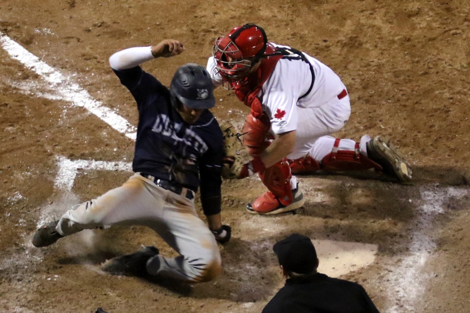 Thunder Bay catcher Gunner Hellstrom tags out Duluth's Julian Escobedo trying to score from second in the 11th innng on Tuesday, June 12, 2018 at Port Arthur Stadium. (Leith Dunick, tbnewswatch.com)