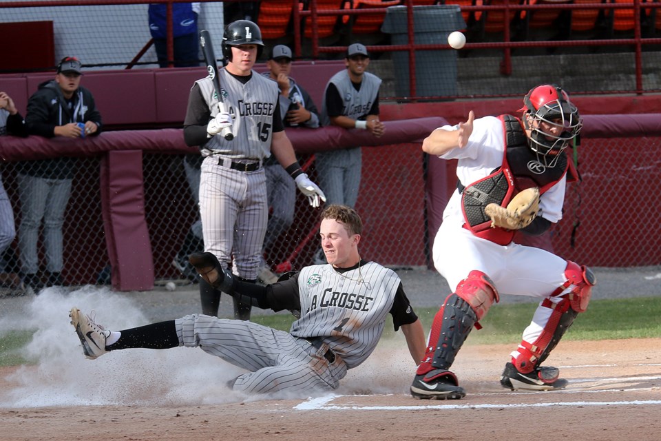La Crosse Loggers leadoff hitter Braiden Ward slides home safely past Thunder Bay Border Cats catcher Evan Russell in the first inning on Monday, June 25, 2018 at Port Arthur Stadium. (Leith Dunick, tbnewswatch.com)