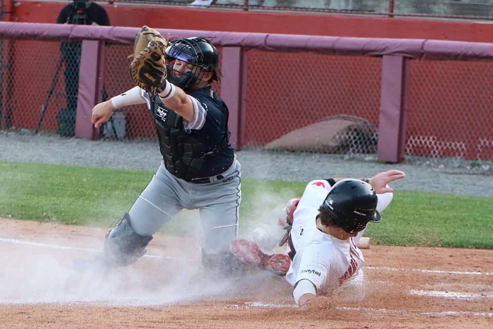 Thunder Bay's Tyler Griggs slides home safely in the third innning on Tuesday, June 6, 2023, past Duluth catcher Michael Gabbard at Port Arthur Stadium. Thunder Bay won the game 6-3. (Leith Dunick, tbnewswatch.com)