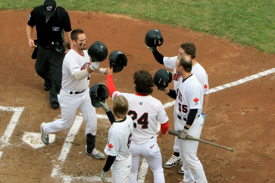 Cole Ketzner (left) is congratulated by his Border Cats teammates after slamming a first-inning grand slam against the Duluth Huskies in Game 1 of their doubleheader on Thursday, June 6, 2024 (Leith Dunick, tbnewswatch.com)