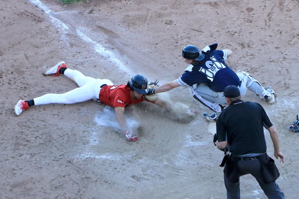 Duluth catcher Ethan Cole tags out Thunder Bay baserunner Ty Hamilton in the ninth inning on Sunday, June 9, 2024. 